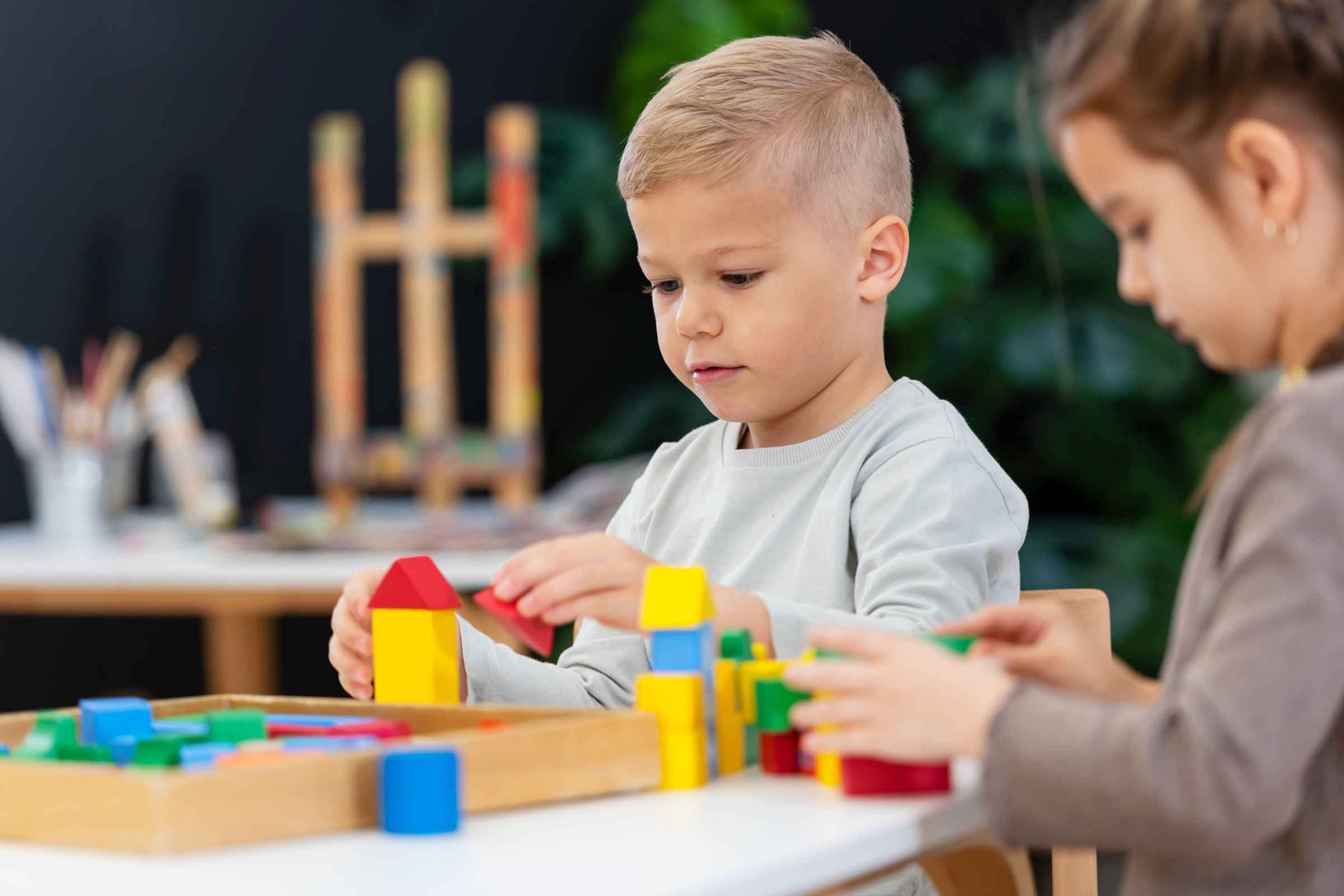 Children play with eco-friendly toys including wooden blocks and child-safe art supplies