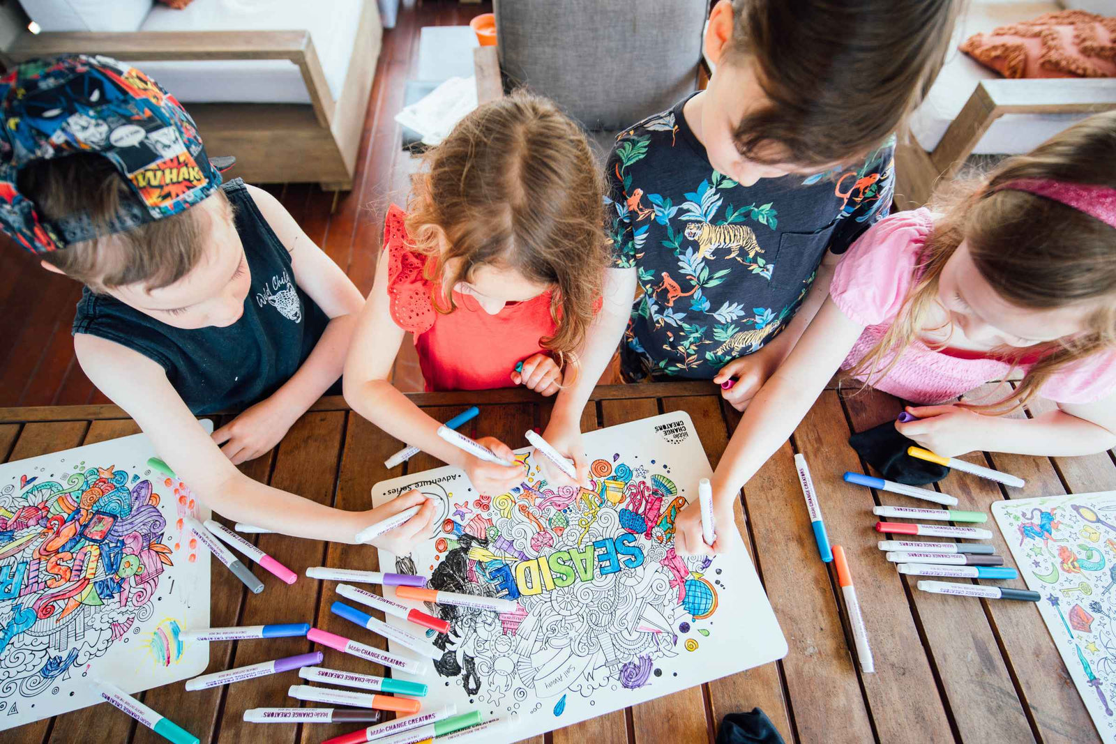4 kids drawing on silicone colouring mats