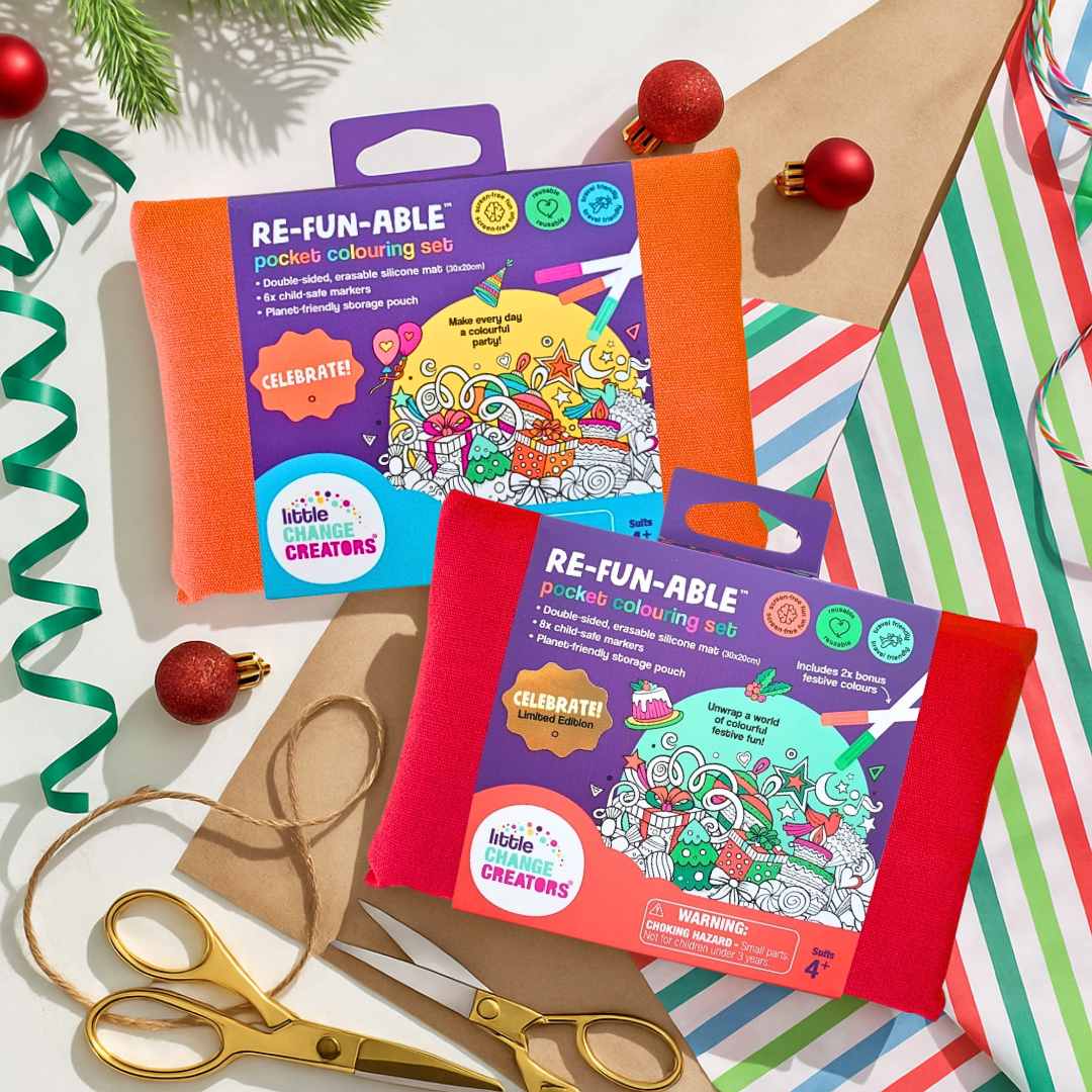 Two pocket-size 'Celebration' reusable colouring sets on a festive background with ribbons and scissors.