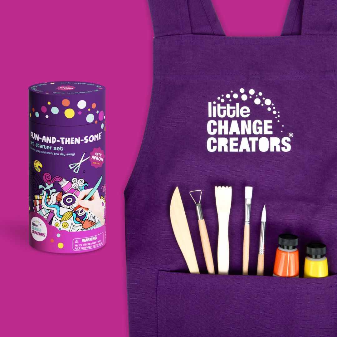 Purple apron with art tools and cylindrical gift box on a purple background.
