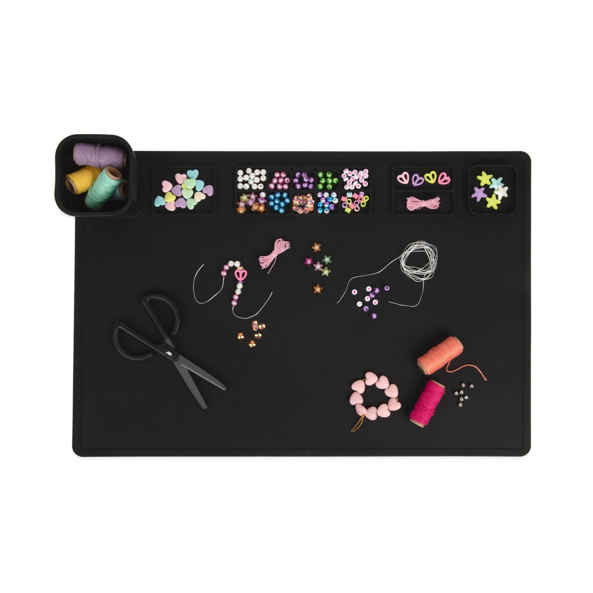 A black silicone craft mat with collapsible cup and in-built palette.