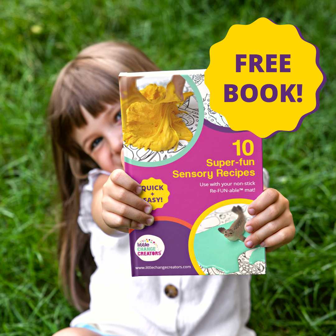 Image of a young girl holding a free downloadable book of super fun sensory recipes