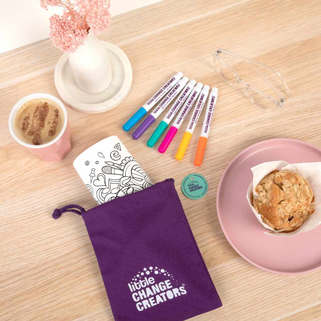 Imagination reusable colour and draw set in bag with colouring markers on table with coffee and cake
