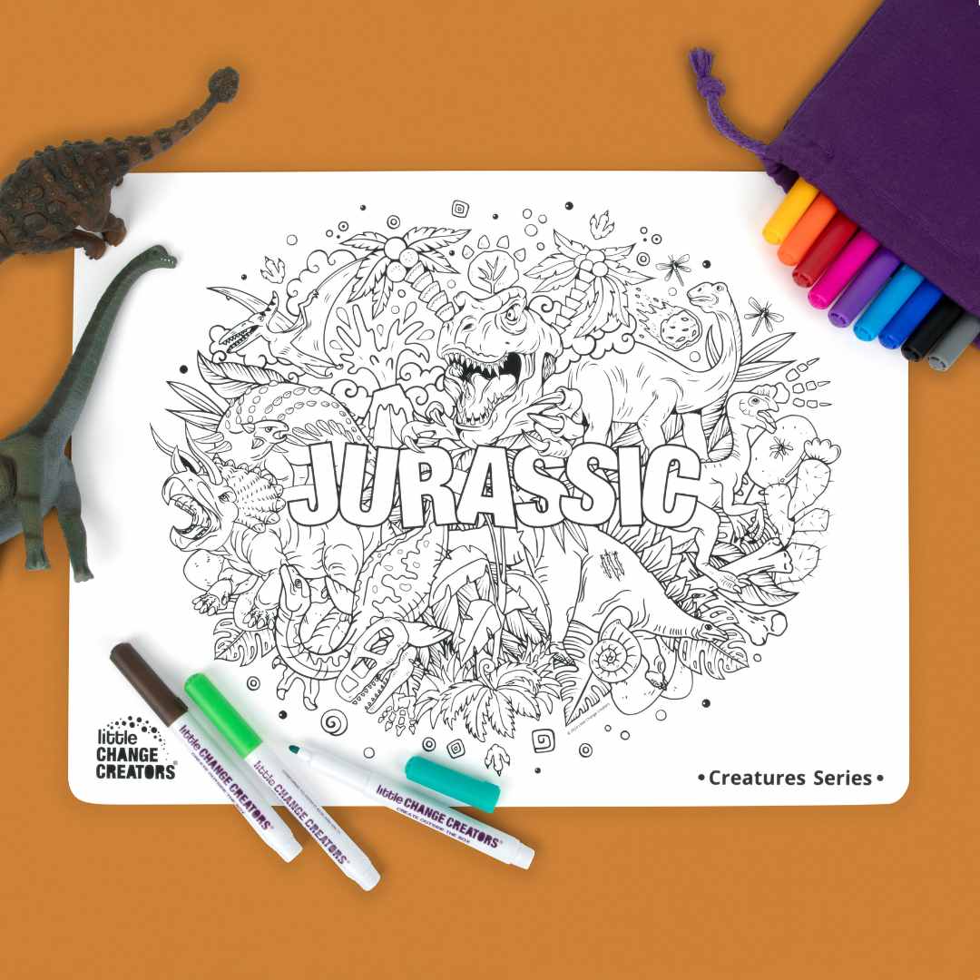 Reusable silicone colouring mat with dinosaur design, markers and a purple fabric pouch on a tan background.