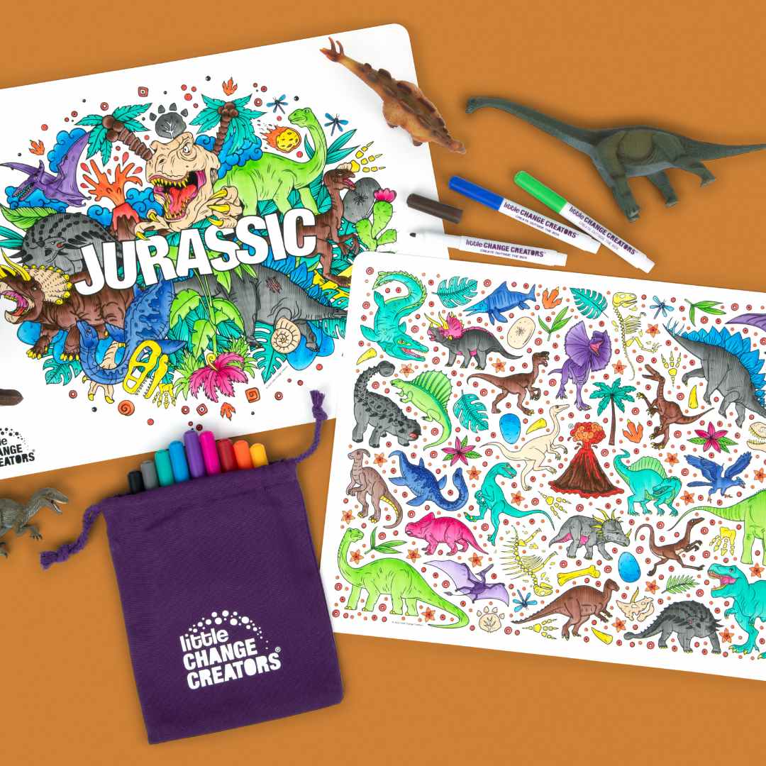 Jurassic Dinosaur Reusable Silicone Drawing and Colouring Mat with purple fabric bag and markers on a tan background.