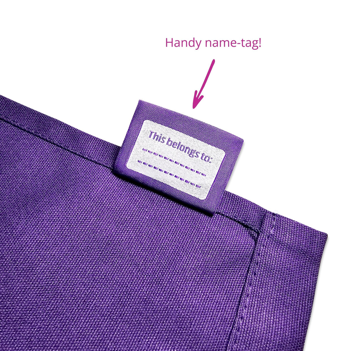 A children&#39;s purple apron featuring a name tag.