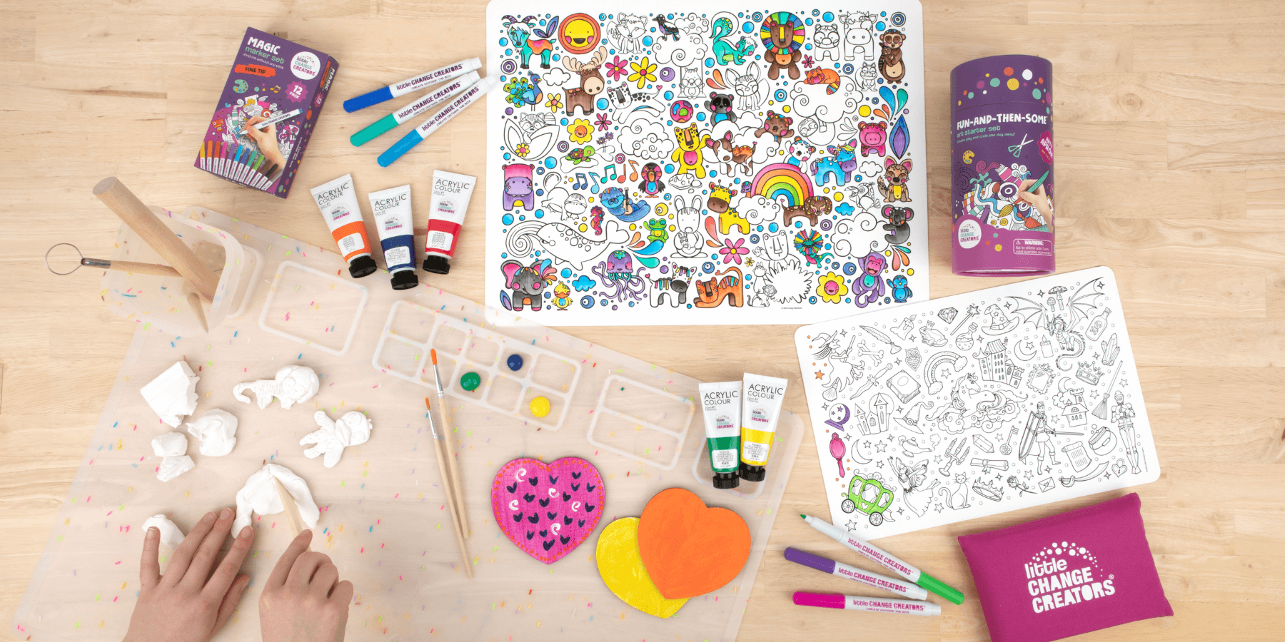 Reusable silicone colouring mats, craft mat and kids' art supplies on a wooden background.