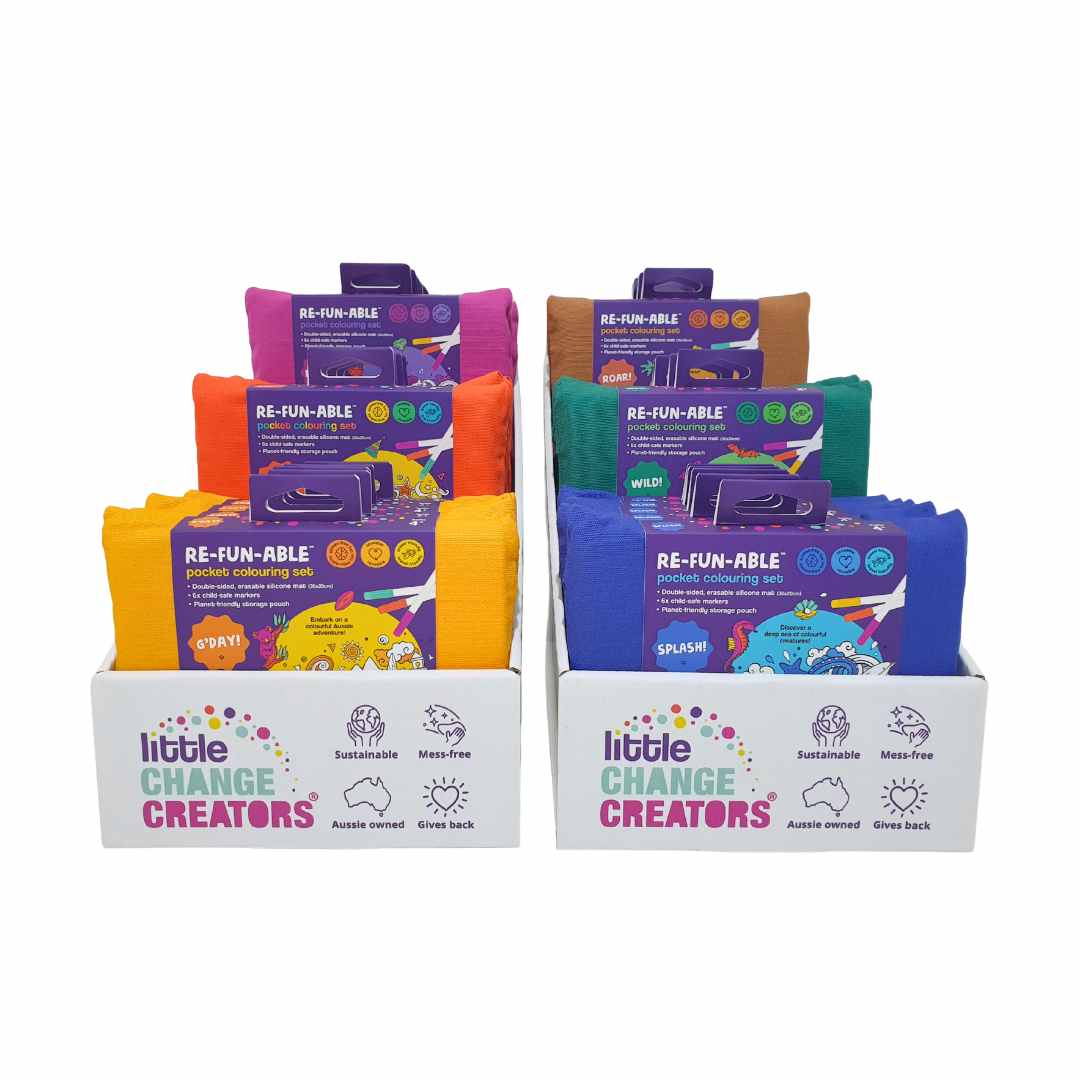 Countertop display boxes of colourful kids&#39; products with &#39;Little Change Creators&#39; branding on a white background.