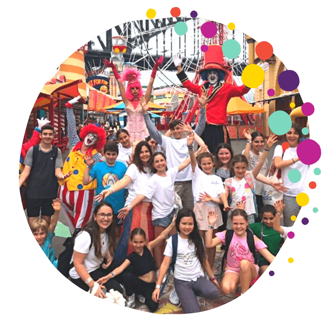 Image of children waving and looking happy with clowns at a park - photo supplied by Little Dreamers Australia