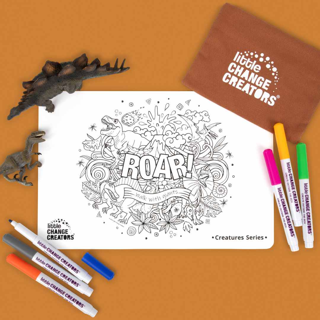 Silicone colouring mat with dinosaur design and markers on a tan background, featuring 'Little Change Creators' branding.
